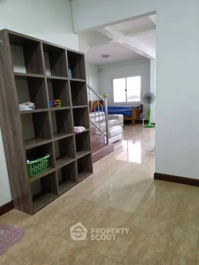 Spacious living area with modern shelving and bright natural light
