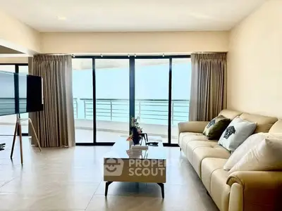 Spacious living room with ocean view and modern decor in luxury apartment