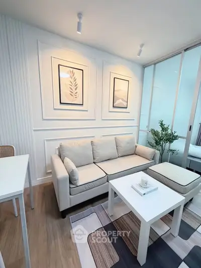 Modern living room with cozy sofa, stylish decor, and natural light in a contemporary apartment.