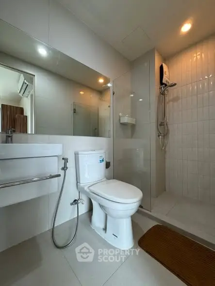 Modern bathroom with sleek fixtures and glass shower enclosure