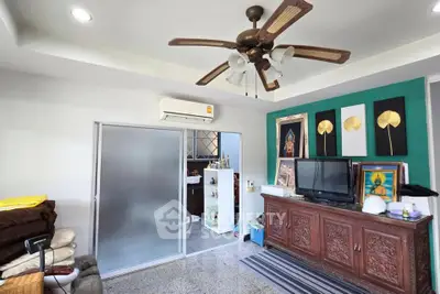 Charming living room with ceiling fan and traditional decor, perfect for cozy family gatherings.