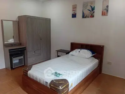 Cozy bedroom with single bed, wardrobe, and modern decor in a minimalist style.