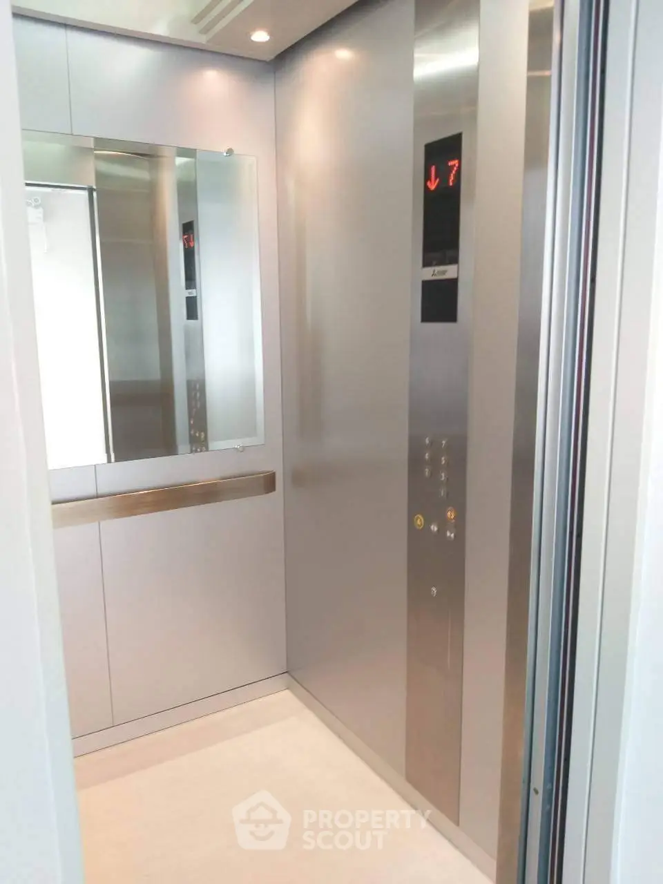 Modern elevator interior with sleek design and mirror, perfect for upscale buildings.
