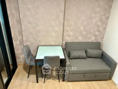 Modern living room with stylish sofa and dining table in a cozy apartment setting.