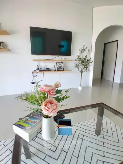 Modern living room with wall-mounted TV and stylish decor