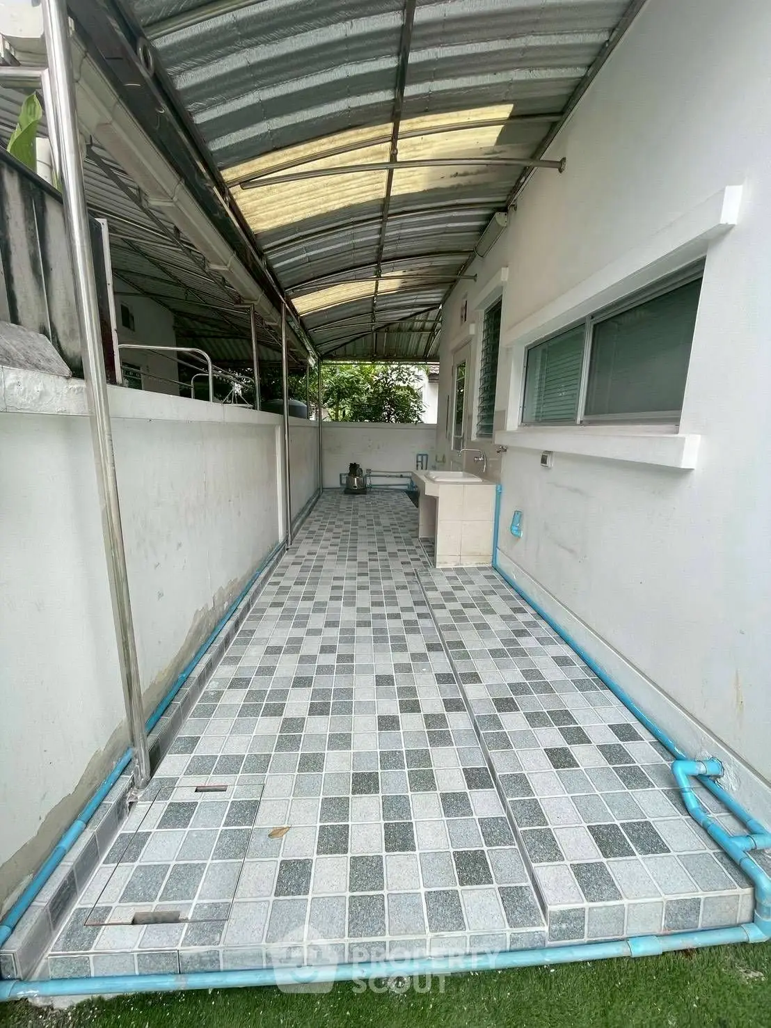Charming covered outdoor walkway with tiled flooring and modern design