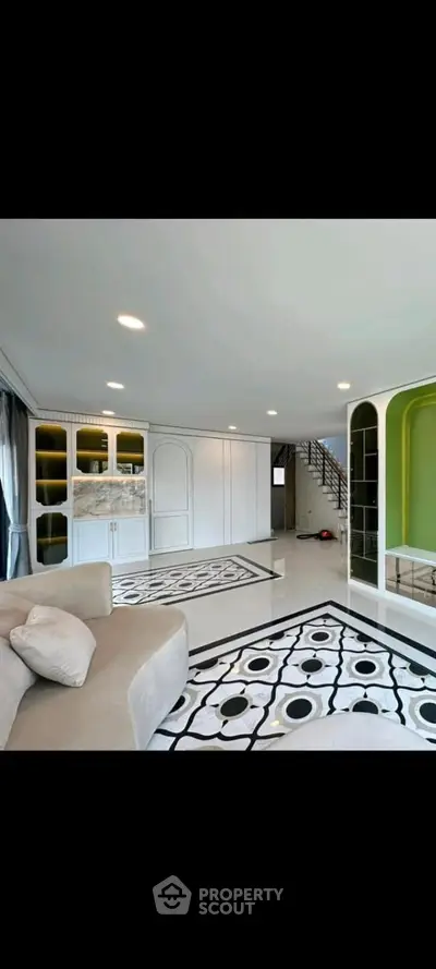 Spacious modern living room with unique flooring and elegant decor