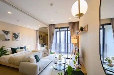 Luxurious modern bedroom with balcony and stylish decor in high-rise apartment.
