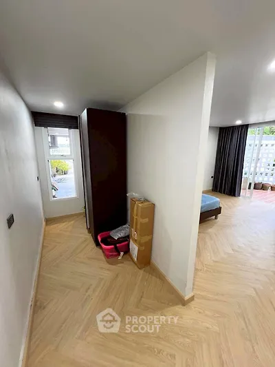 Spacious bedroom with modern flooring and natural light