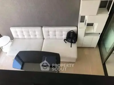 Modern living room with stylish white sofa and sleek black coffee table