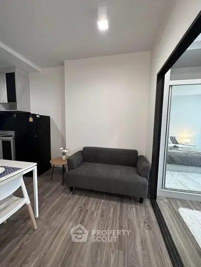 Modern apartment interior with cozy living area and sleek kitchen design.