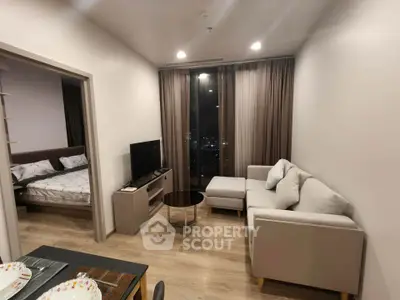 Modern living room with cozy sofa and city view, adjacent to stylish bedroom.