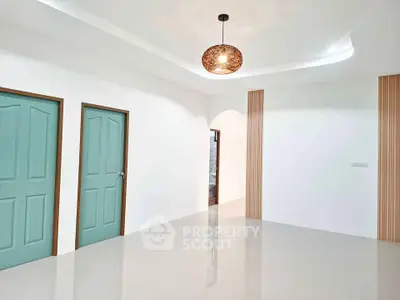 Spacious modern interior with elegant lighting and stylish doors, perfect for contemporary living.