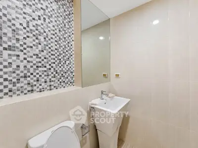 Modern bathroom with stylish tile accent wall and sleek fixtures