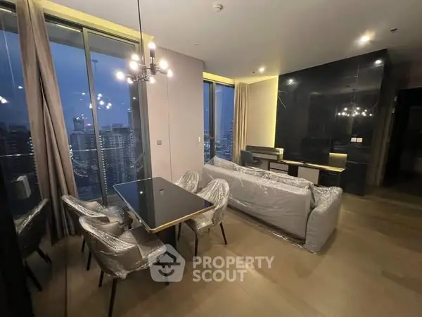 Luxurious high-rise living room with stunning city view and modern furnishings.