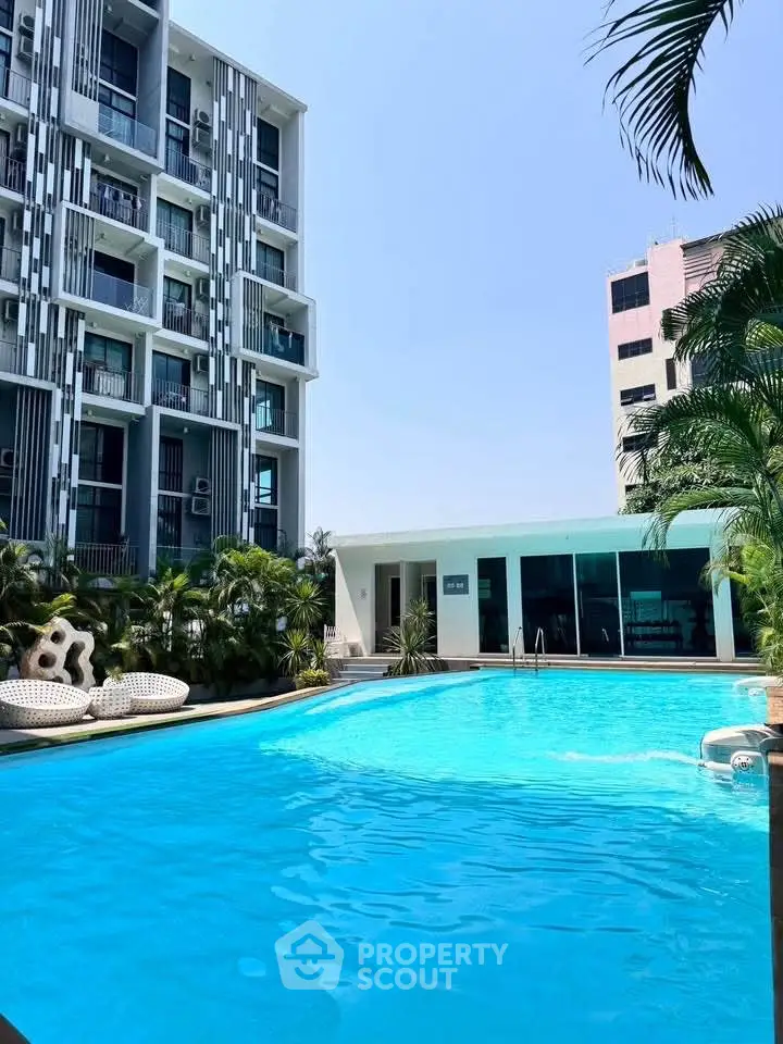 Luxurious apartment complex with stunning pool and modern architecture.