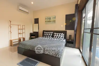 Modern bedroom with large window and stylish decor