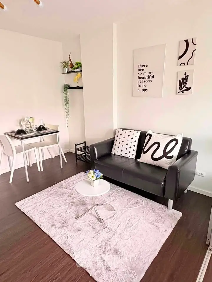 Chic living room with modern decor, cozy sofa, and stylish dining area, perfect for urban living.