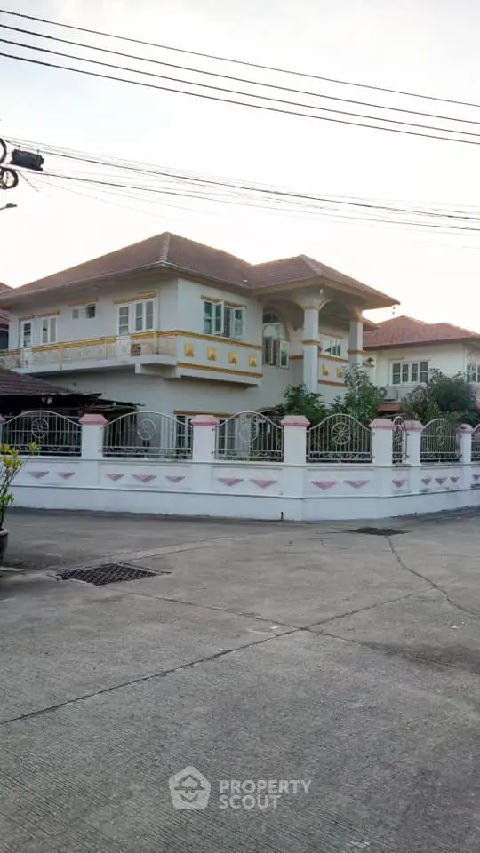 Charming two-story house with fenced yard and elegant balcony in a serene neighborhood.