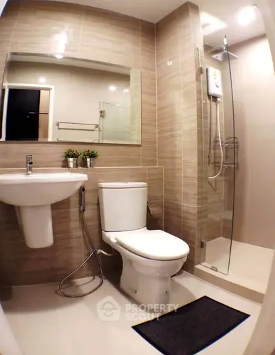 Modern bathroom with sleek fixtures and glass shower enclosure