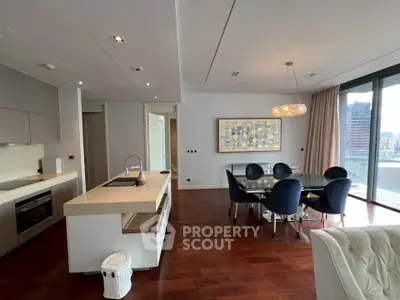 Luxurious open-plan living room with modern kitchen and city view balcony