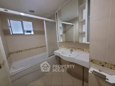 Modern bathroom with bathtub and sleek vanity in a stylish apartment.