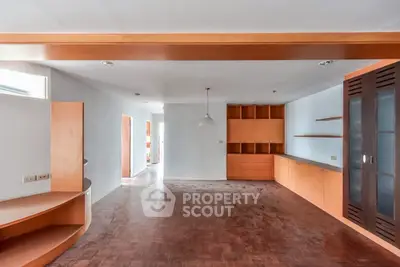 Spacious living room with wooden flooring and built-in cabinets