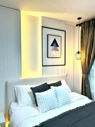 Modern bedroom with stylish decor and cozy lighting