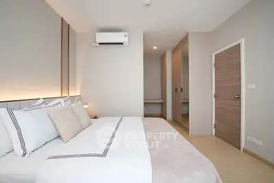 Modern bedroom with stylish decor and air conditioning in a contemporary apartment.