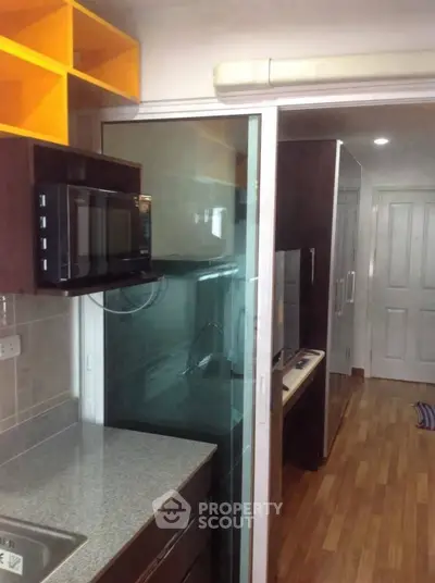 Compact kitchen with modern appliances and sleek design in urban apartment