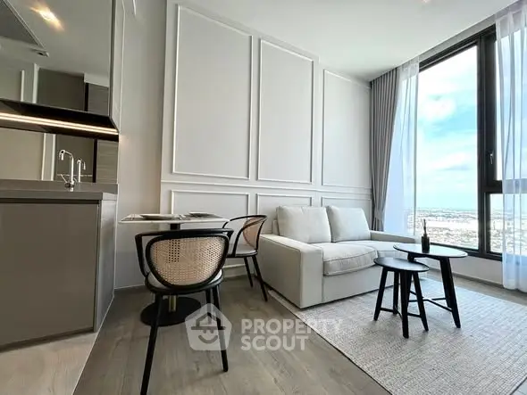 Modern living room with panoramic window and stylish furniture in high-rise apartment