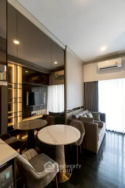 Luxurious modern living room with elegant furniture and large windows for natural light.