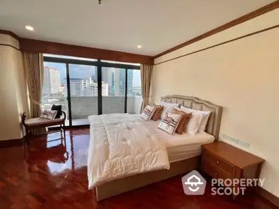 Spacious bedroom with city view and elegant wooden flooring