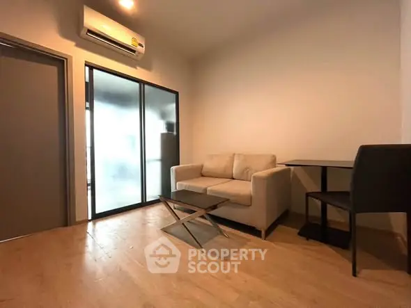 Modern living room with sleek furniture and air conditioning, perfect for cozy urban living.