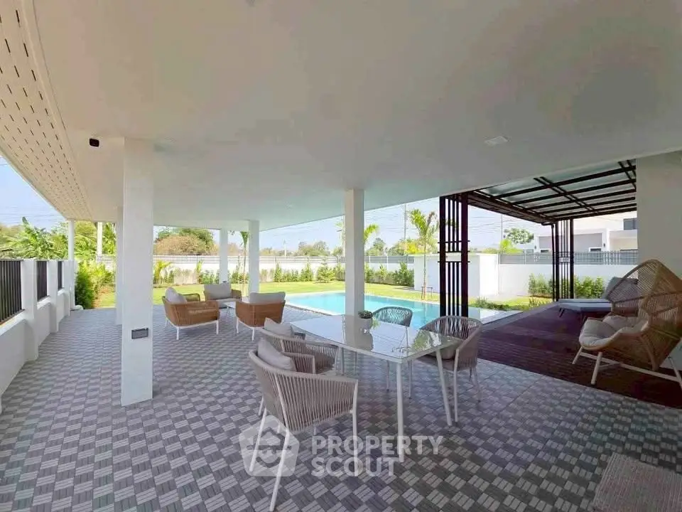 Spacious outdoor patio with modern furniture and pool view in luxury home