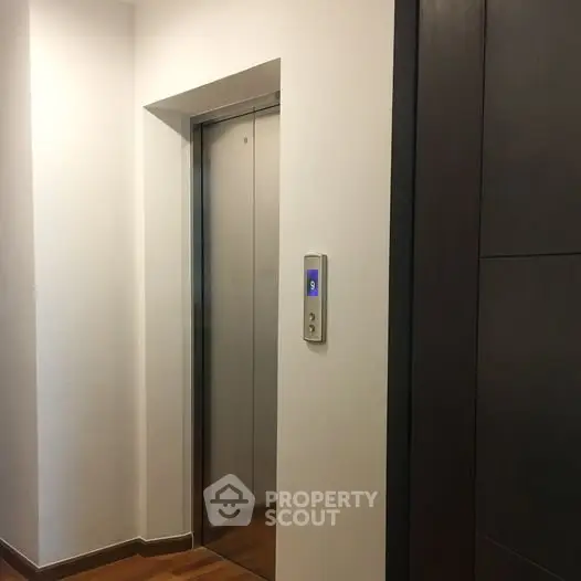 Modern building elevator with sleek design and wooden flooring