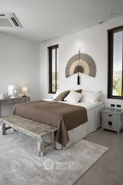 Elegant bedroom with rustic decor and serene ambiance, featuring a cozy bed and stylish furnishings.