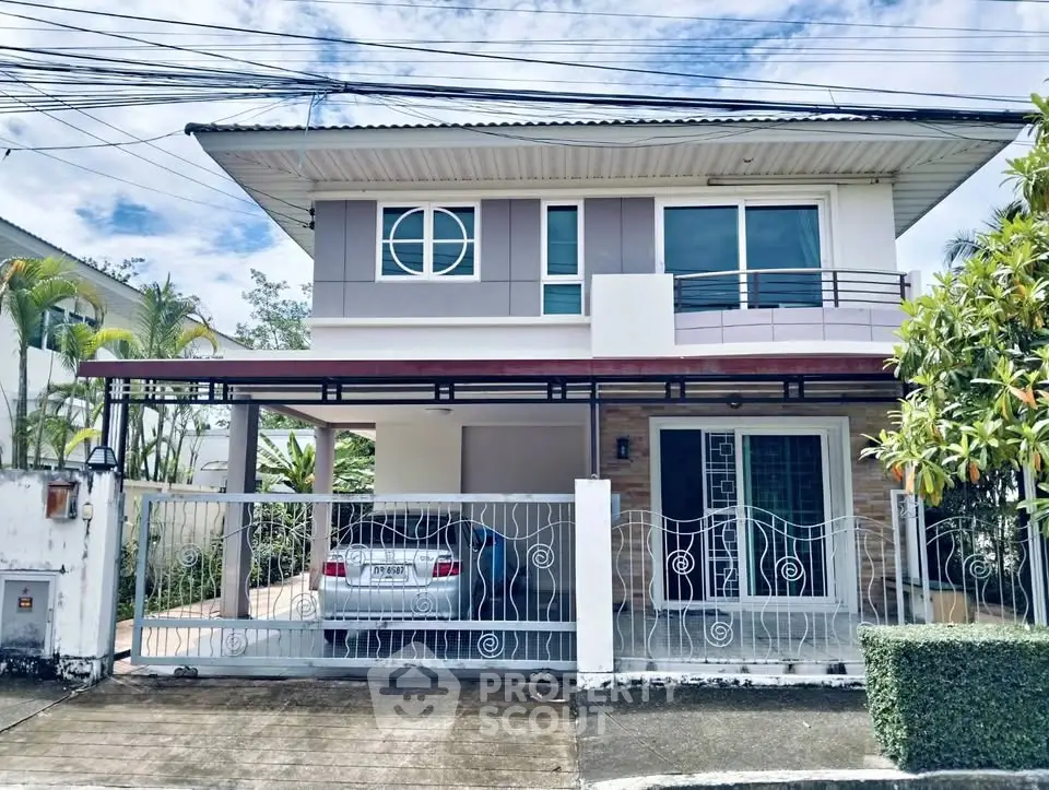 Modern two-story house with carport and stylish facade in a serene neighborhood.