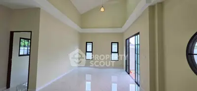 Spacious living room with high ceilings and large windows for natural light.