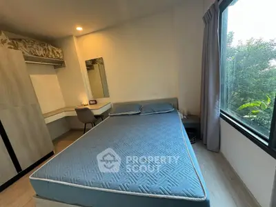 Cozy bedroom with large window and modern furnishings