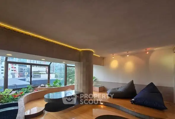 Luxurious modern living room with panoramic city views and stylish seating area.