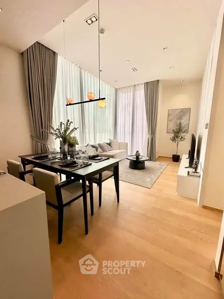 Elegant open-plan living and dining area with high ceilings and modern decor