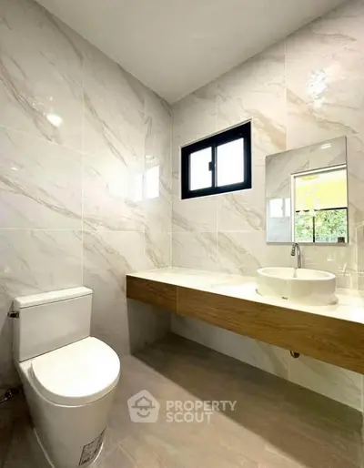 Modern bathroom with sleek design, featuring a stylish vanity and elegant tile work.