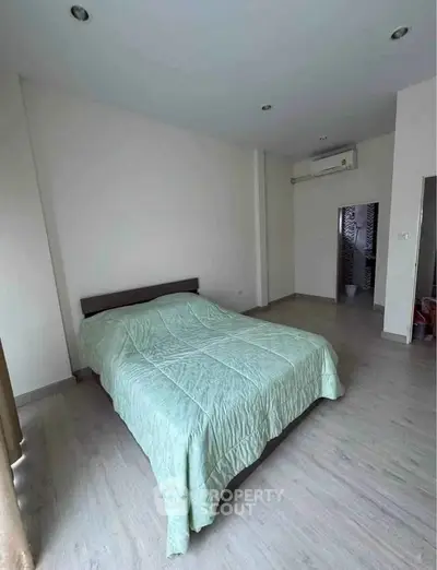 Spacious bedroom with modern decor and air conditioning, perfect for comfort and relaxation.