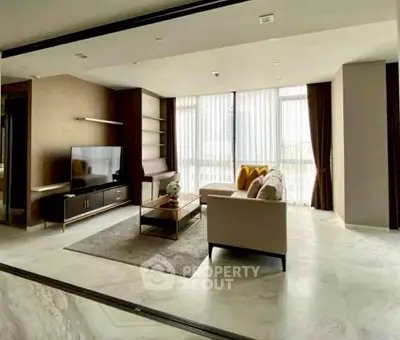 Spacious modern living room with large windows and elegant decor
