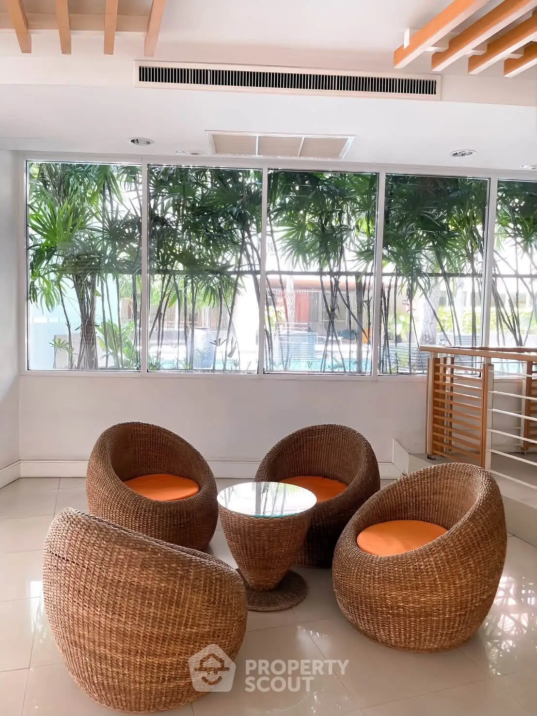 Stylish wicker seating area with pool view, perfect for relaxation and social gatherings.