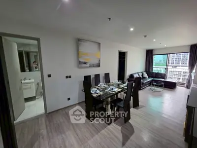 Modern living room with dining area and city view balcony in luxury apartment