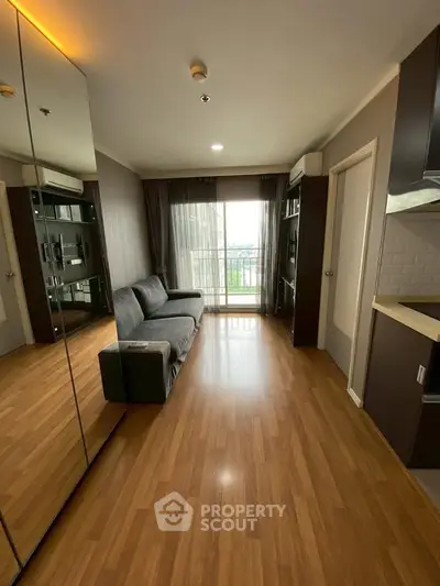 Modern living room with hardwood floors and balcony view