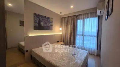 Modern bedroom with large window and stylish decor in high-rise apartment