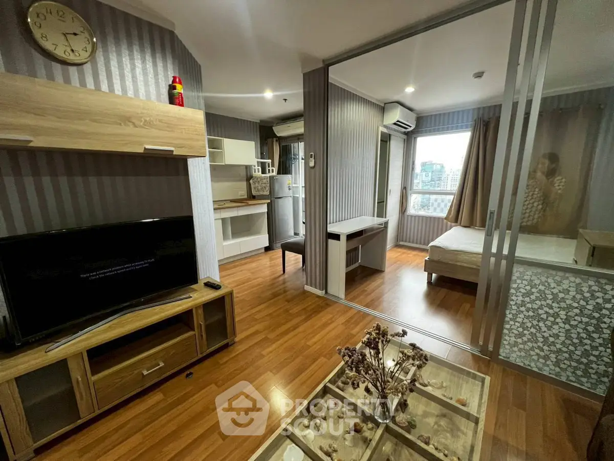 Modern apartment interior with open layout, featuring a cozy living room and stylish kitchen.